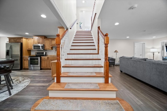 stairway with hardwood / wood-style flooring