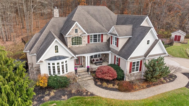 craftsman-style house with french doors and a storage shed