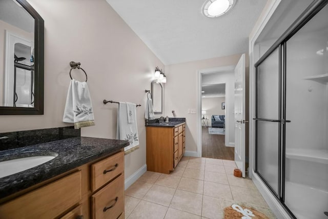 bathroom with vanity, tile patterned floors, and an enclosed shower