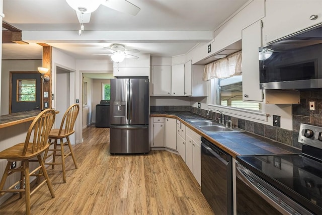 454 Orchard Beach Rd, North East, PA 16428 - kitchen with black appliances, ceiling fan, white cabinetry, light wood-style flooring, and tile counters