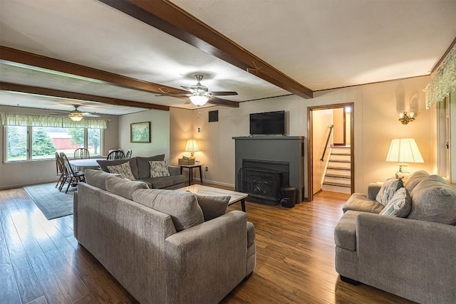 454 Orchard Beach Rd, North East, PA 16428 - living room with beam ceiling, wood finished floors, a fireplace, a ceiling fan, and stairs