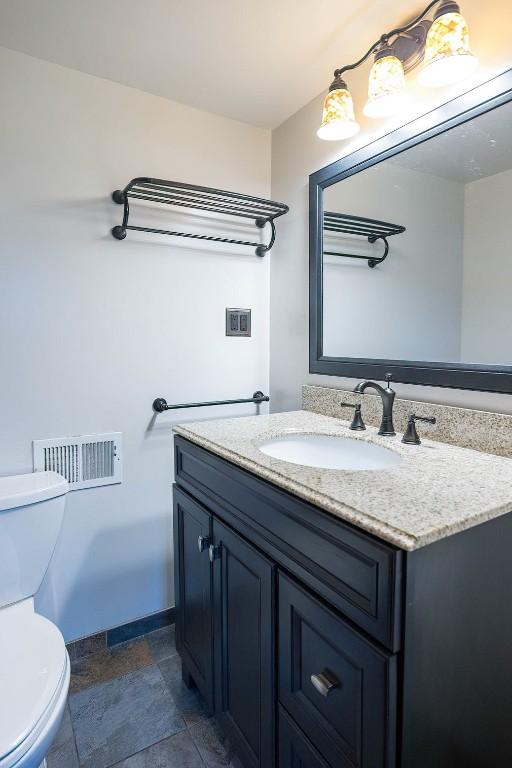 454 Orchard Beach Rd, North East, PA 16428 - half bath featuring vanity and stone finish flooring