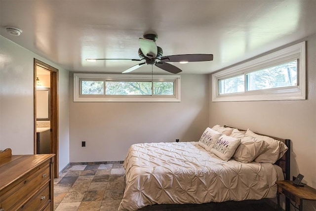 454 Orchard Beach Rd, North East, PA 16428 - bedroom featuring stone finish flooring, a ceiling fan, and ensuite bath