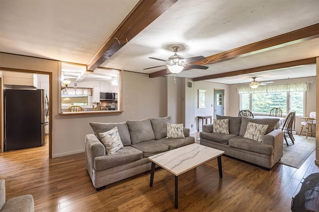 454 Orchard Beach Rd, North East, PA 16428 - living room featuring beamed ceiling, wood finished floors, and a ceiling fan