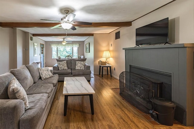 454 Orchard Beach Rd, North East, PA 16428 - living room with beam ceiling, ceiling fan, wood finished floors, and a fireplace
