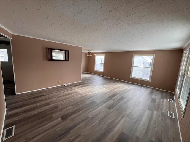 unfurnished room featuring crown molding, dark hardwood / wood-style flooring, and ceiling fan