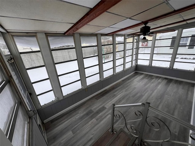 unfurnished sunroom with beam ceiling and ceiling fan