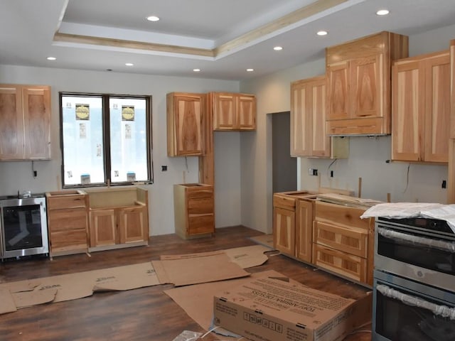 kitchen with wine cooler, light brown cabinets, recessed lighting, range, and a raised ceiling