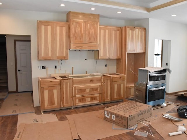 kitchen with recessed lighting, light brown cabinetry, double oven, wood finished floors, and baseboards