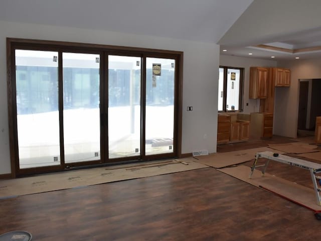 interior space with recessed lighting, a raised ceiling, visible vents, and light wood finished floors