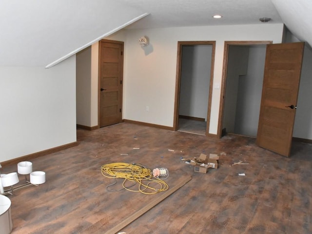 bonus room featuring lofted ceiling, wood finished floors, and baseboards