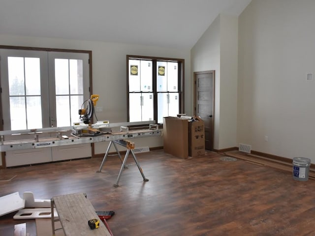 miscellaneous room featuring lofted ceiling, visible vents, baseboards, and wood finished floors