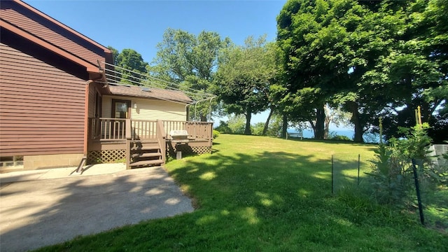 view of yard featuring a wooden deck and a patio area