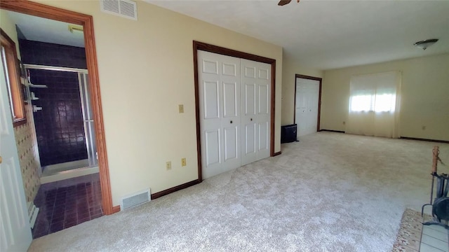 unfurnished bedroom with ceiling fan and light colored carpet