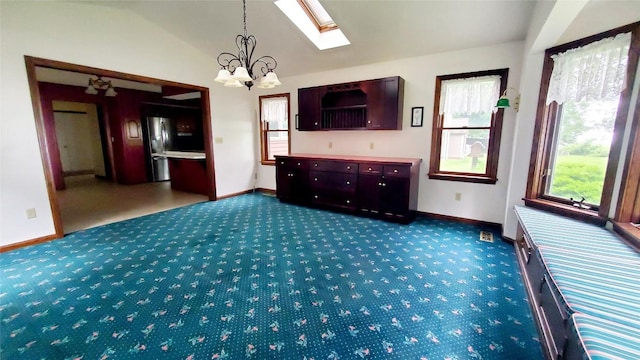 interior space with carpet flooring, lofted ceiling, and an inviting chandelier