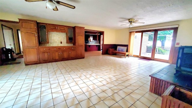 tiled living room featuring a textured ceiling