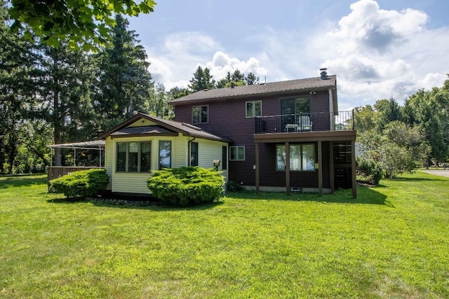 rear view of property featuring a lawn