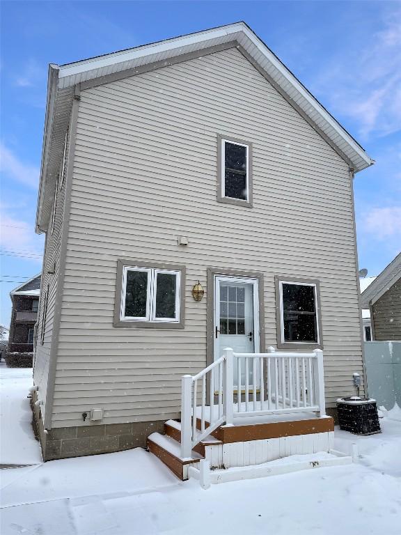 view of snow covered rear of property