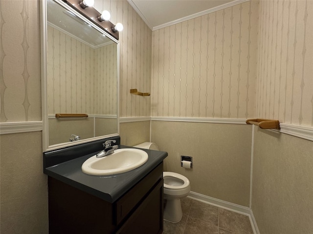 bathroom featuring vanity, tile patterned flooring, ornamental molding, and toilet