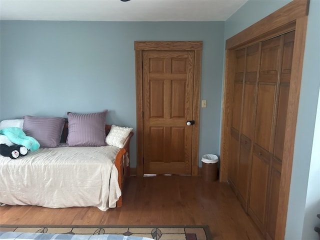 bedroom with wood-type flooring and a closet