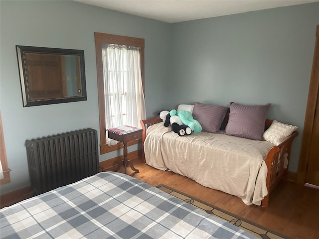 bedroom featuring light wood-type flooring and radiator