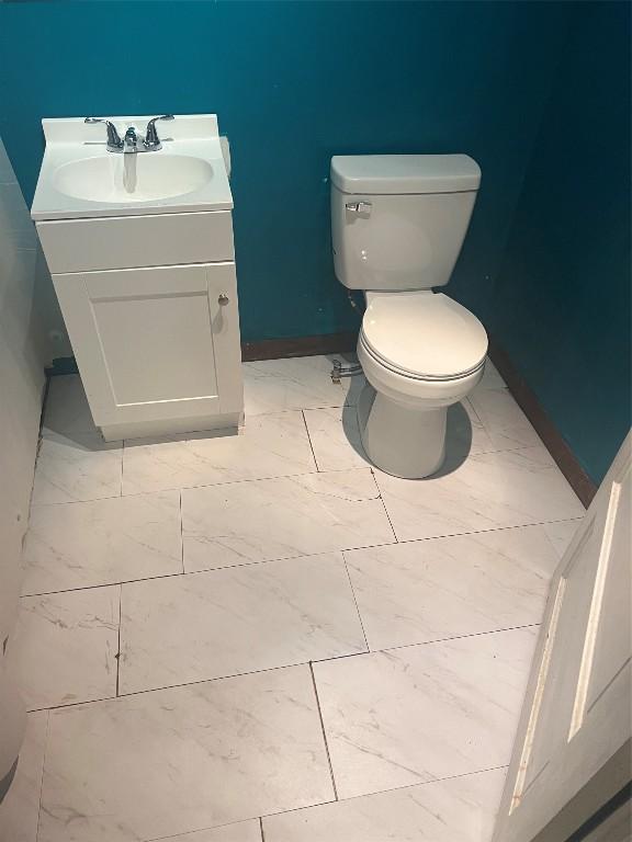 bathroom featuring vanity and toilet