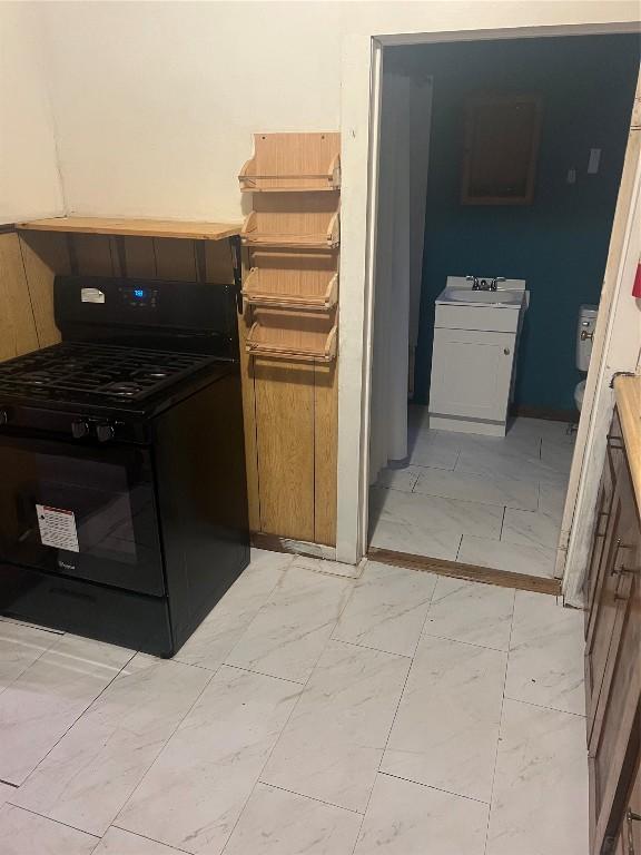 kitchen featuring sink and black range with gas cooktop