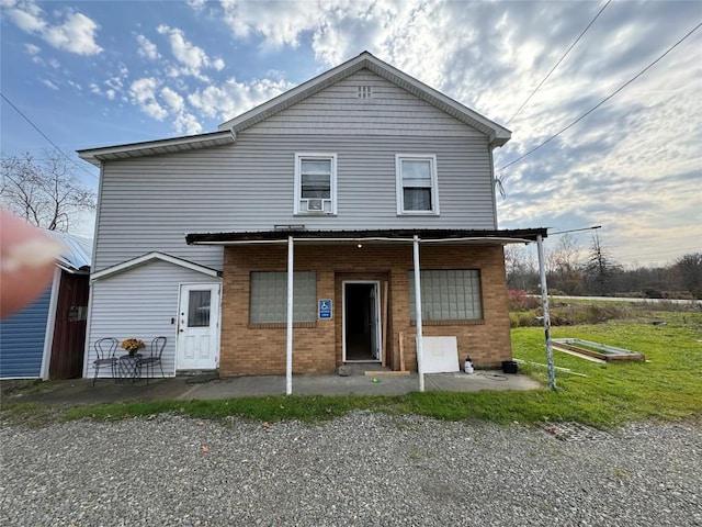 back of property featuring a yard