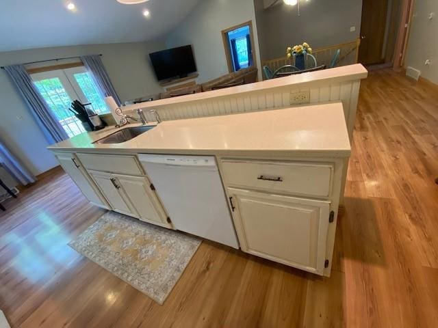 2156 Depot St, Waterford, PA 16441 - kitchen featuring dishwasher, a sink, vaulted ceiling, light wood finished floors, and white cabinets