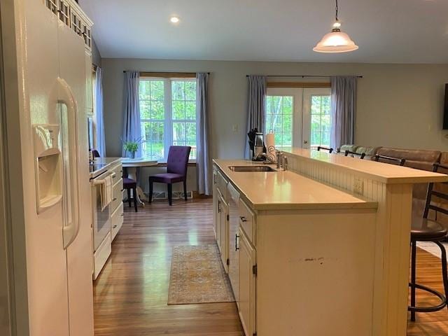 2156 Depot St, Waterford, PA 16441 - kitchen with white fridge with ice dispenser, healthy amount of natural light, a kitchen bar, and light countertops