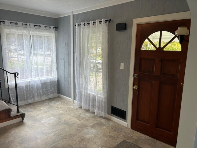 entryway featuring ornamental molding