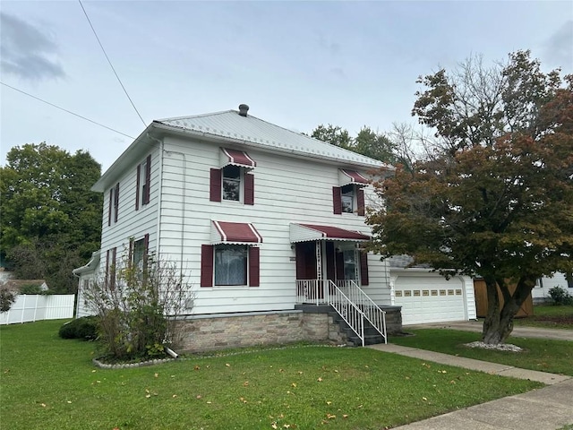 view of property with a front yard and a garage