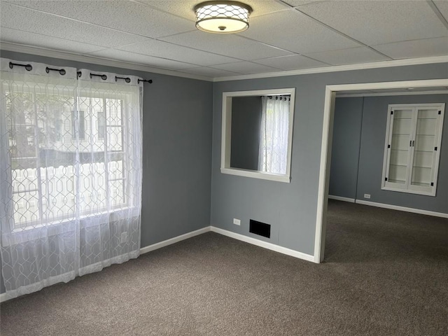 unfurnished room with dark carpet, a healthy amount of sunlight, and crown molding