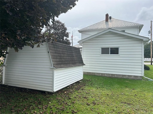 view of side of home with a yard