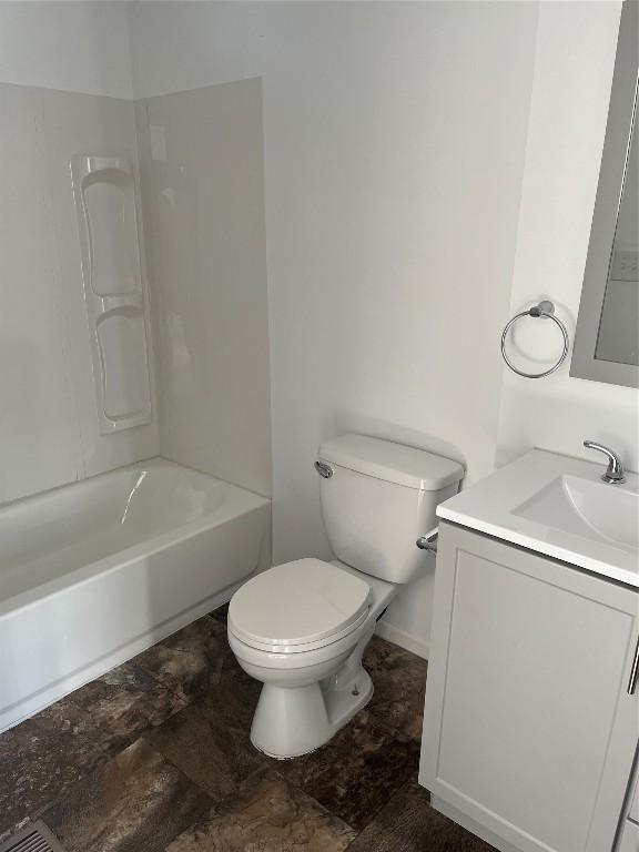 full bathroom featuring vanity, bathing tub / shower combination, and toilet