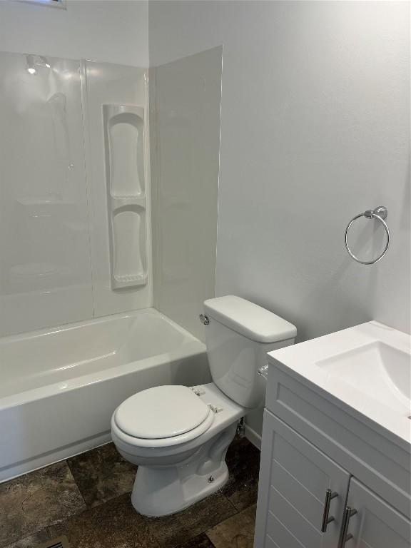 full bathroom with shower / tub combination, vanity, and toilet