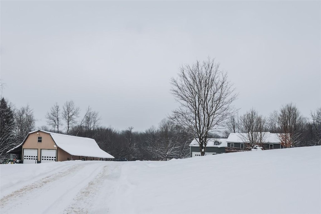 yard covered in snow featuring an outbuilding