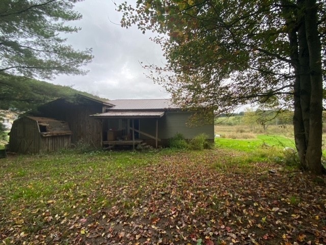 back of house with an outdoor structure