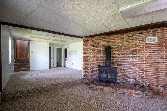 5130 W Stancliff Rd, Mckean, PA 16426 - unfurnished living room featuring a drop ceiling, visible vents, carpet, stairway, and a wood stove