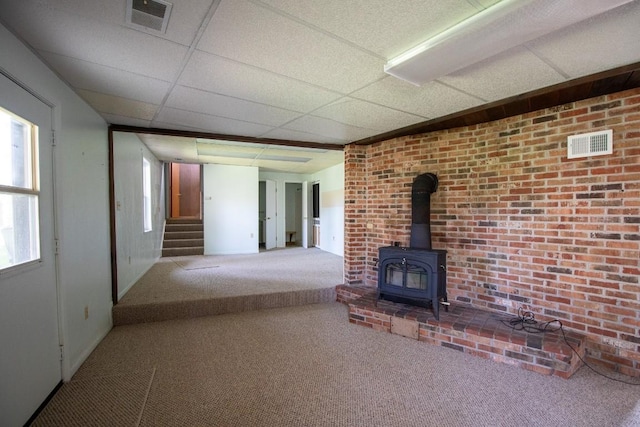 5130 W Stancliff Rd, Mckean, PA 16426 - unfurnished living room with visible vents, carpet, stairs, and a wood stove