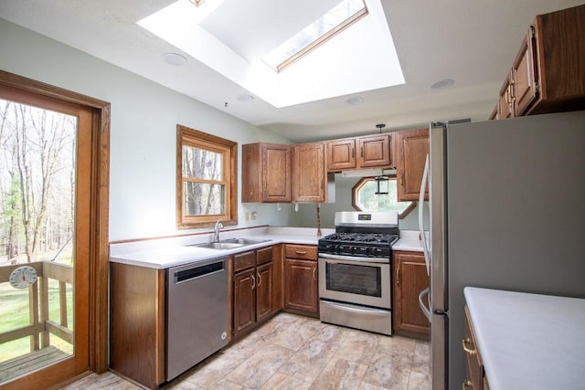 5130 W Stancliff Rd, Mckean, PA 16426 - kitchen featuring brown cabinetry, appliances with stainless steel finishes, a sink, and a skylight