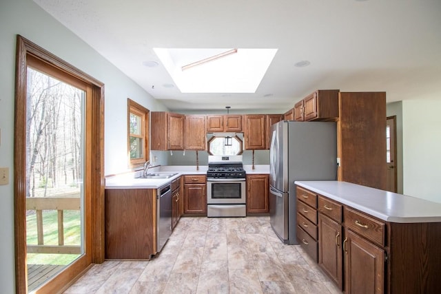 5130 W Stancliff Rd, Mckean, PA 16426 - kitchen with stainless steel appliances, a peninsula, a sink, a skylight, and light countertops