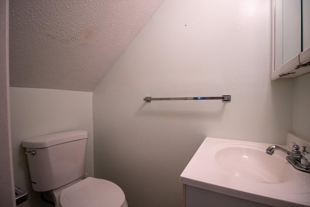 5130 W Stancliff Rd, Mckean, PA 16426 - bathroom featuring vaulted ceiling, toilet, vanity, and a textured ceiling