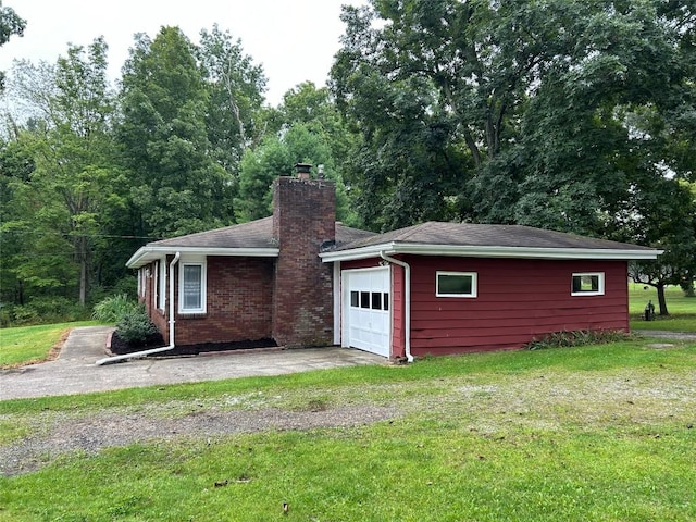 back of property featuring a yard and a garage