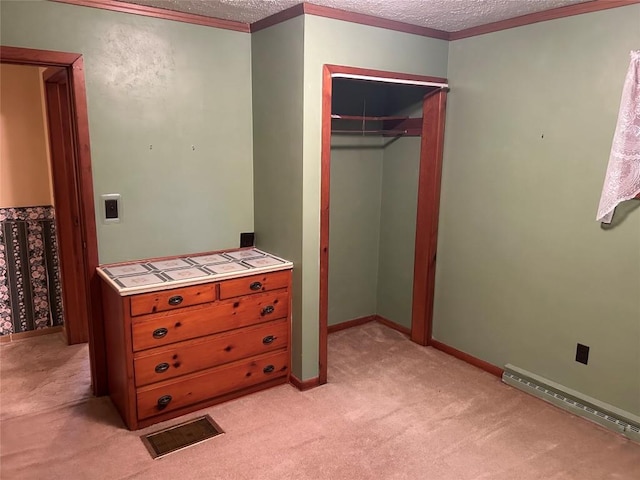 bedroom with a textured ceiling, baseboard heating, light carpet, and a closet