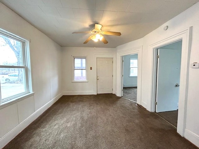 interior space with carpet floors, baseboards, and a ceiling fan