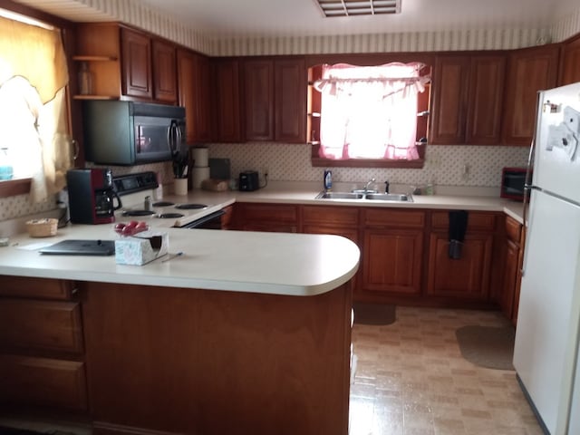 kitchen with open shelves, light countertops, a sink, white appliances, and a peninsula