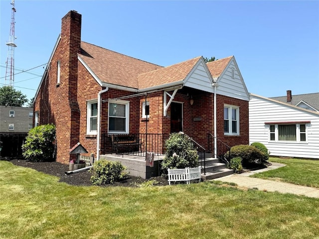 3524 French St, Erie, PA 16504 - view of front of home featuring a chimney, brick siding, roof with shingles, and a front yard