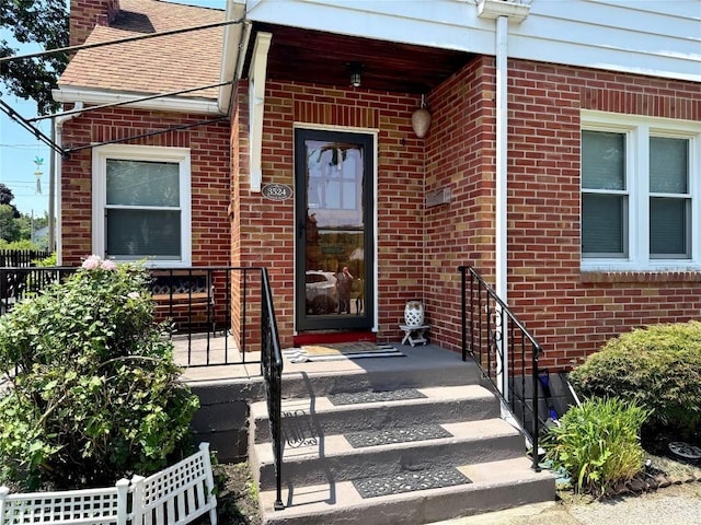 3524 French St, Erie, PA 16504 - entrance to property featuring brick siding, a chimney, and a shingled roof