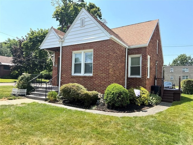 3524 French St, Erie, PA 16504 - view of side of home with brick siding, a yard, and a shingled roof